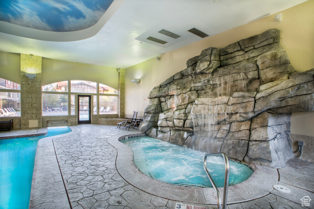View of swimming pool with an indoor in ground hot tub