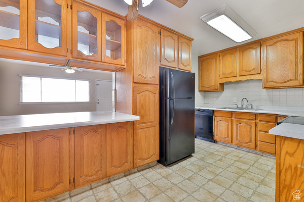 Kitchen featuring light tile floors, ceiling fan, tasteful backsplash, black appliances, and sink