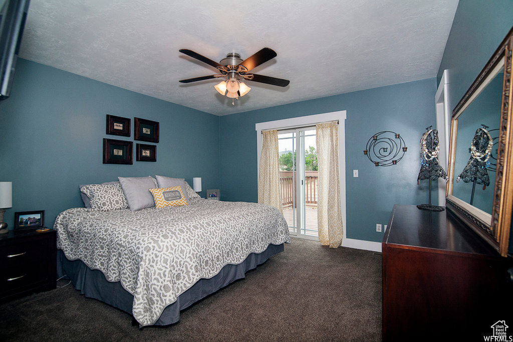Carpeted bedroom with ceiling fan, access to outside, and a textured ceiling