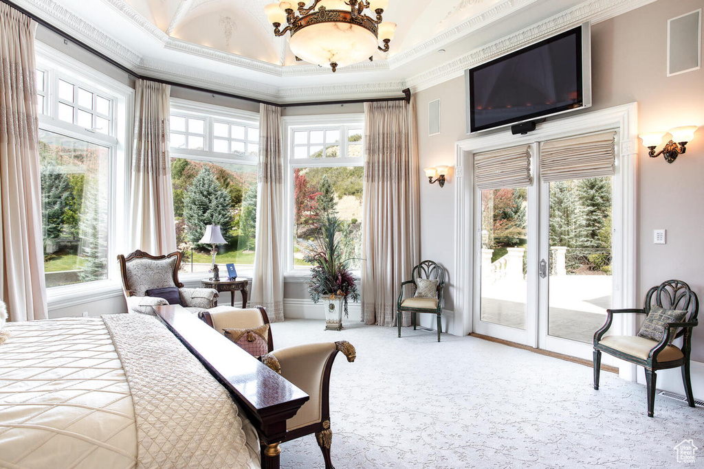 Carpeted bedroom with multiple windows, ornamental molding, access to exterior, and french doors