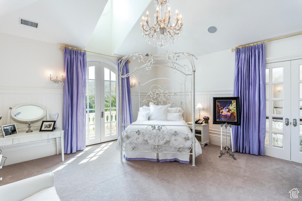 Bedroom featuring access to exterior, a notable chandelier, light carpet, and french doors