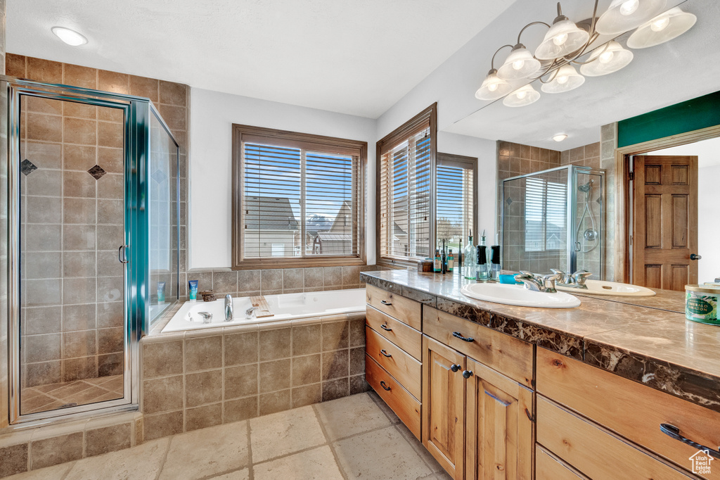 Bathroom featuring plus walk in shower, tile floors, and vanity with extensive cabinet space