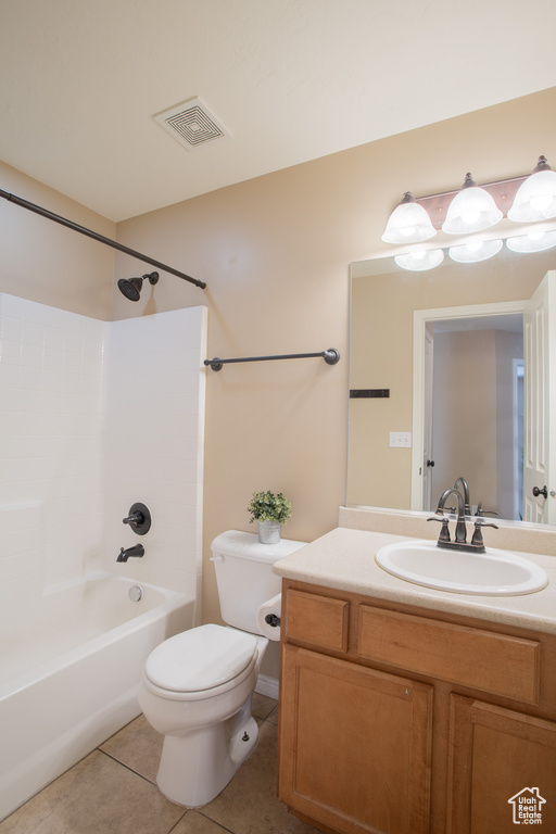 Full bathroom featuring vanity, tile floors, toilet, and tub / shower combination