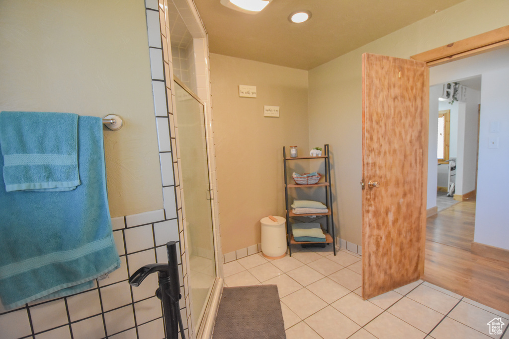 Bathroom featuring walk in shower and wood-type flooring
