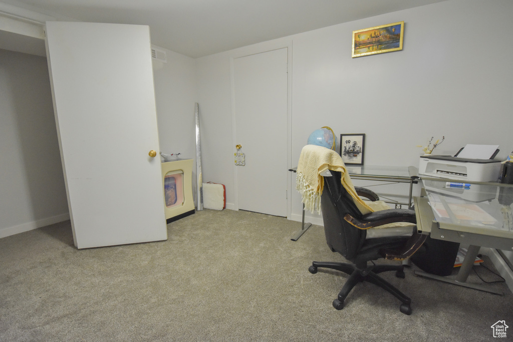 Office area featuring light carpet