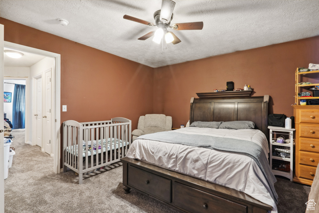 Bedroom featuring ceiling fan, a textured ceiling, and carpet flooring