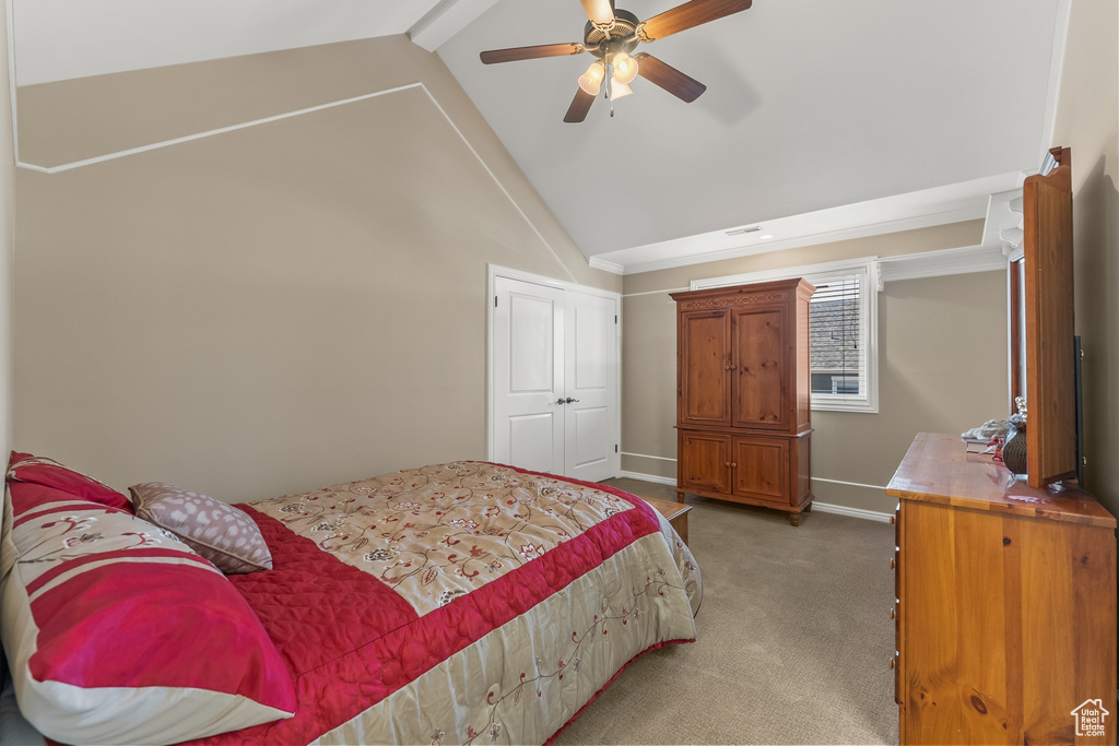 Carpeted bedroom with ceiling fan, beamed ceiling, and high vaulted ceiling