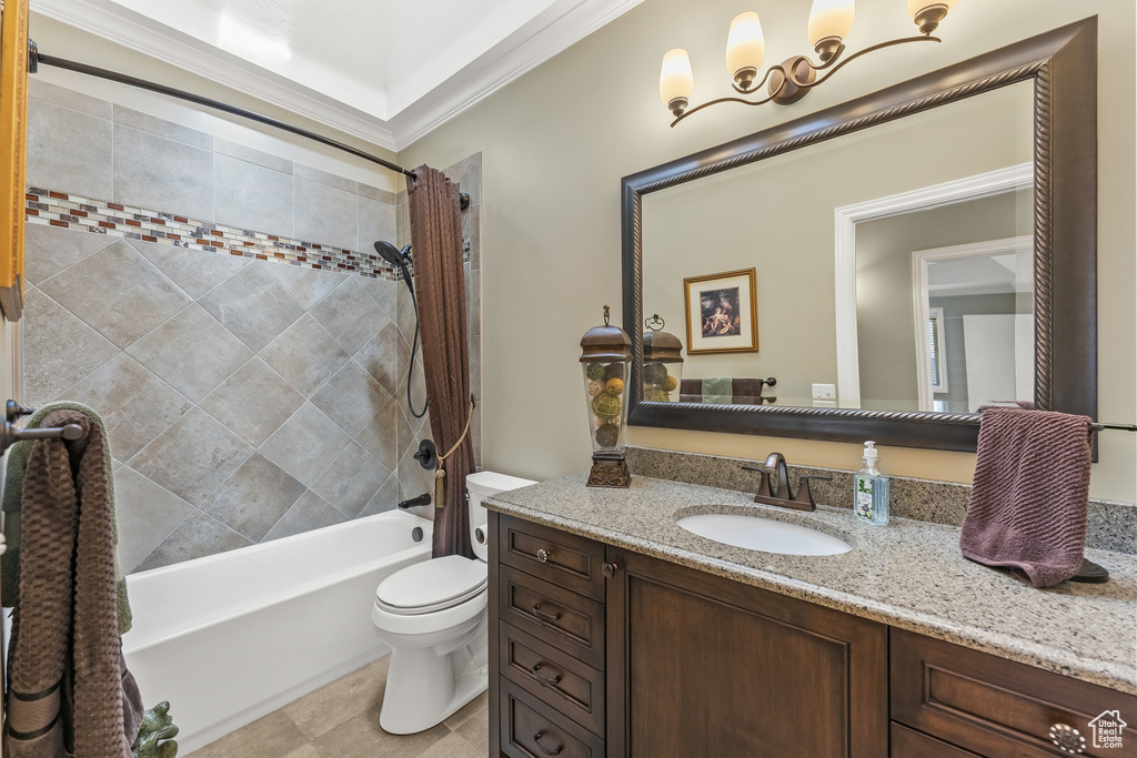 Full bathroom with toilet, ornamental molding, shower / bath combination with curtain, tile floors, and oversized vanity