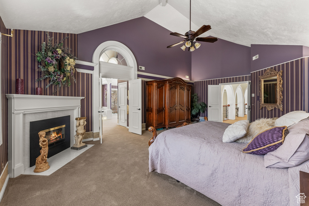 Bedroom featuring high vaulted ceiling, ceiling fan, and light colored carpet