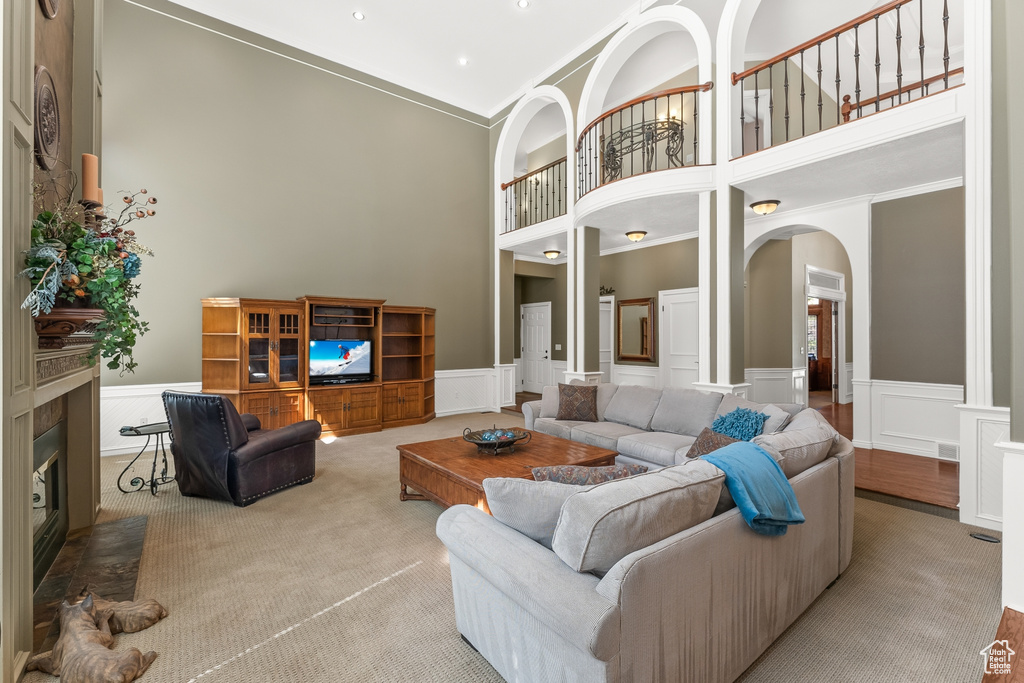 Living room featuring ornamental molding and a high ceiling
