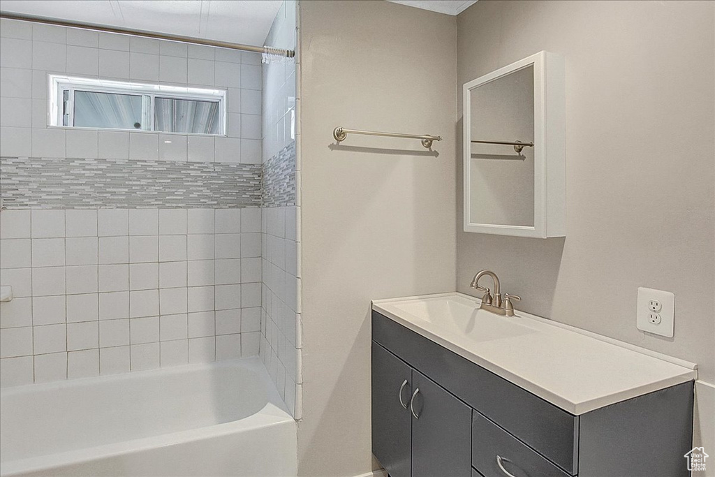 Bathroom with shower / tub combo and vanity