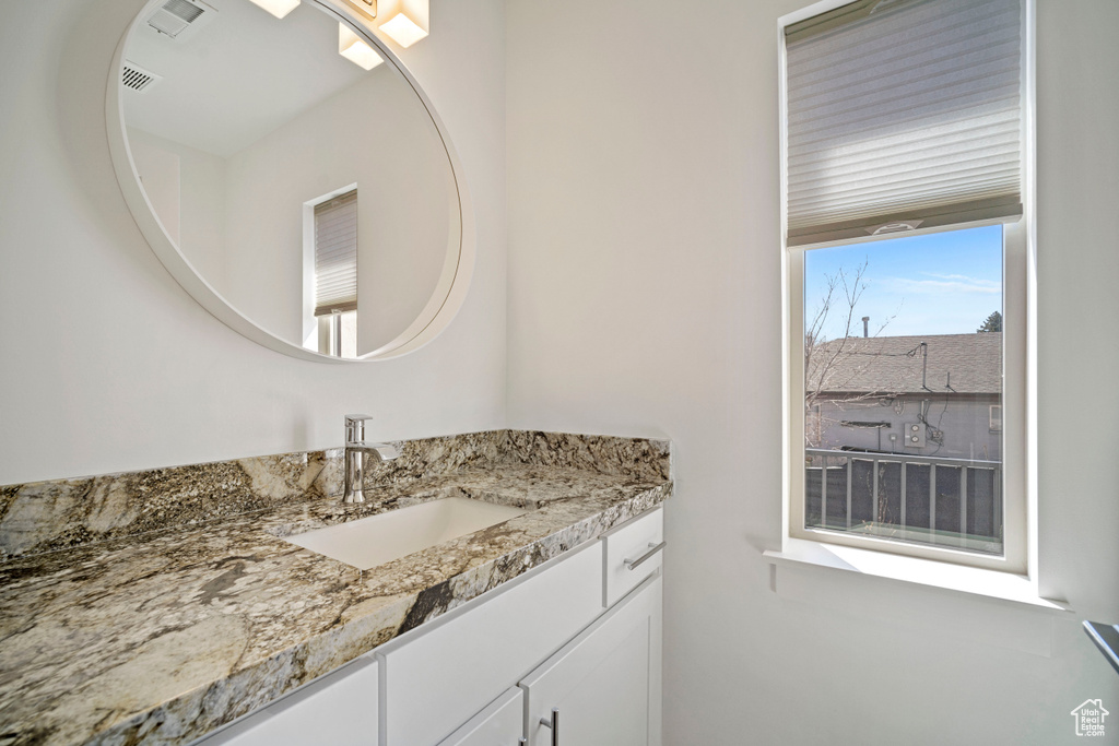 Bathroom featuring vanity and a wealth of natural light