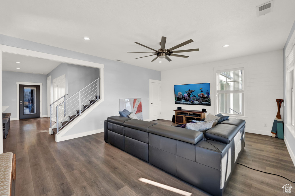 Living room featuring ceiling fan and dark hardwood / wood-style floors
