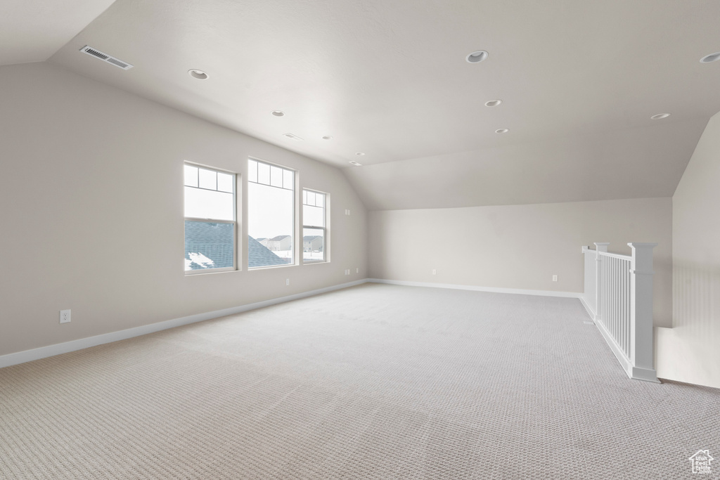 Bonus room featuring lofted ceiling and light colored carpet