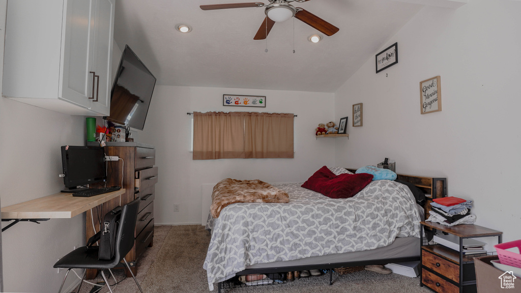 Bedroom with lofted ceiling, carpet, and ceiling fan