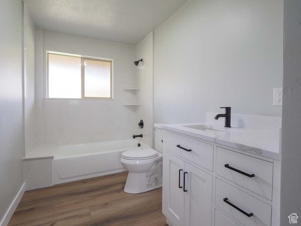 Full bathroom featuring shower / bathing tub combination, toilet, vanity, and hardwood / wood-style flooring