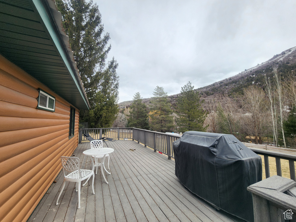 Wooden deck featuring a mountain view and grilling area