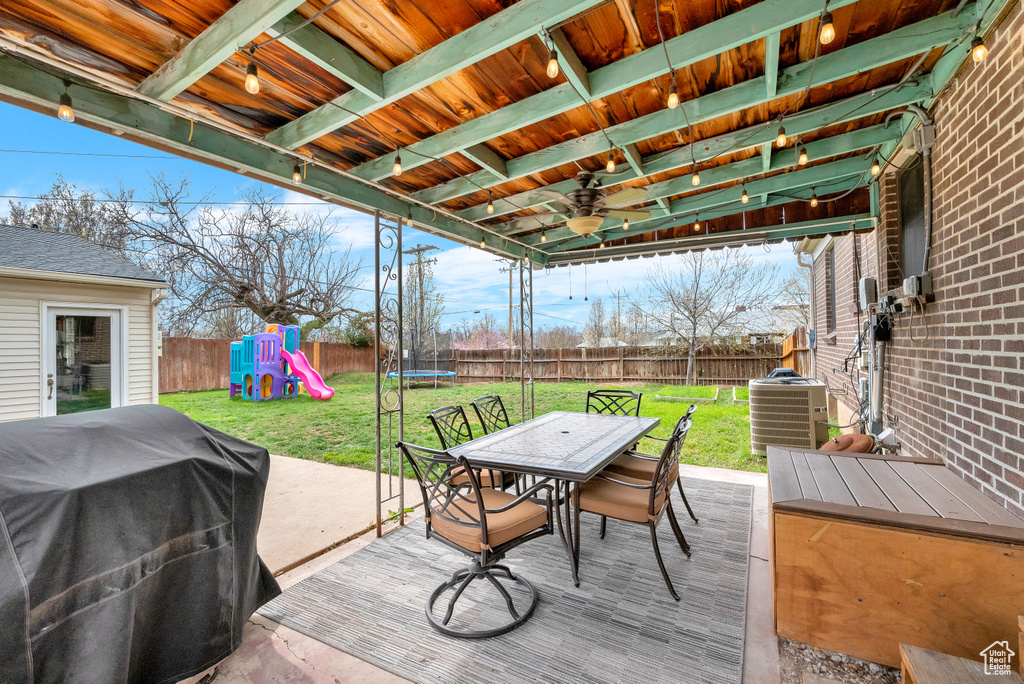 Deck featuring a playground, a yard, central AC, area for grilling, and ceiling fan