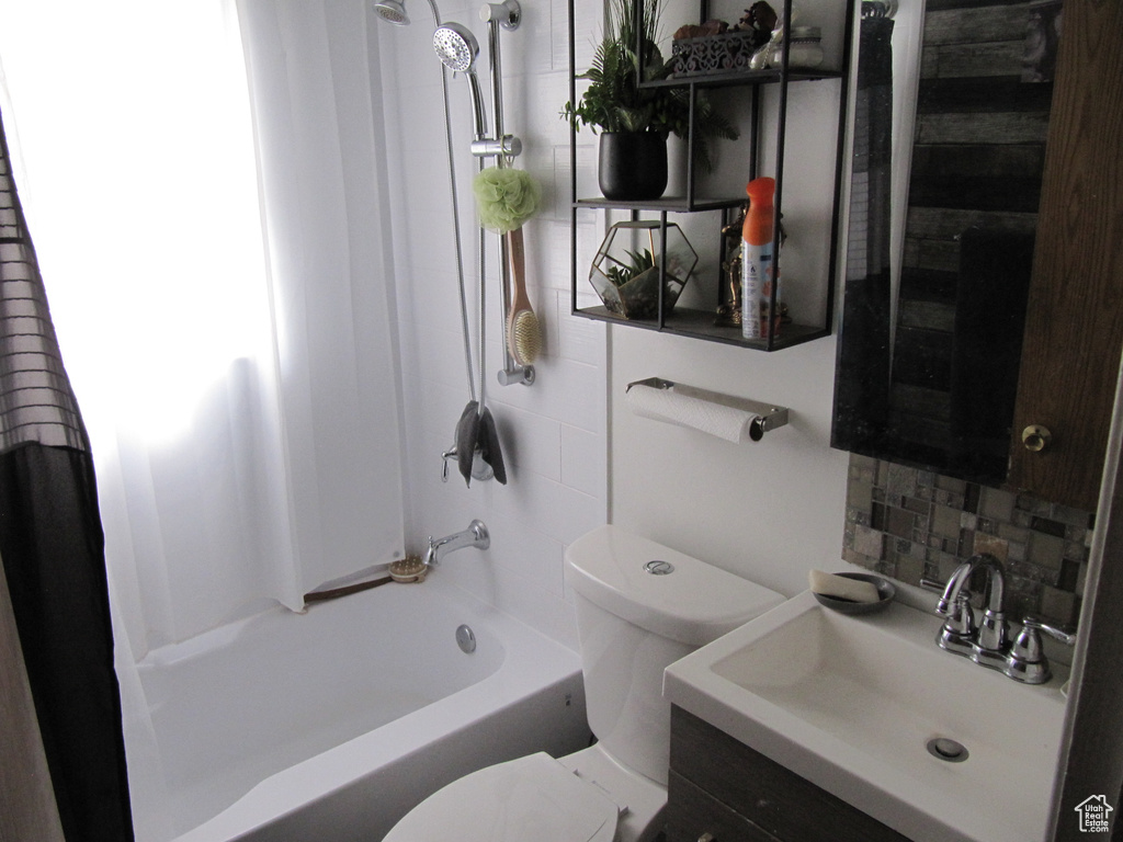 Full bathroom with shower / tub combo with curtain, backsplash, toilet, and vanity