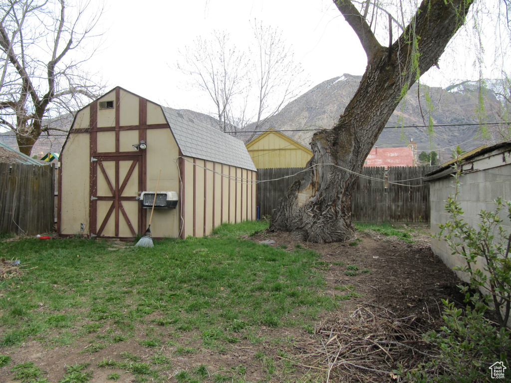 View of yard featuring a mountain view and a storage unit