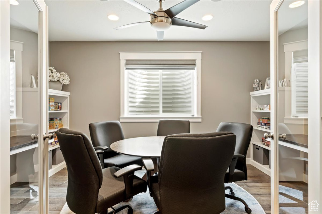 Office area with ceiling fan, a healthy amount of sunlight, and light hardwood / wood-style flooring