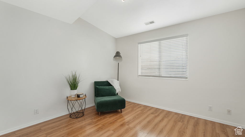 Sitting room featuring light hardwood / wood-style floors and vaulted ceiling