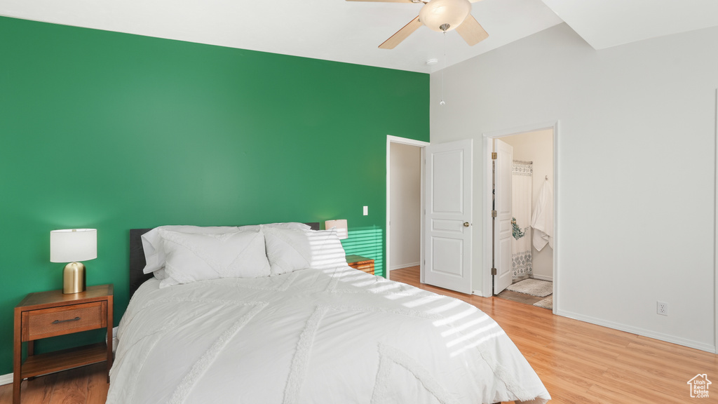 Bedroom featuring ensuite bath, ceiling fan, and hardwood / wood-style flooring