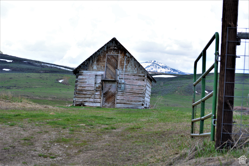 View of outdoor structure with a mountain view and a rural view