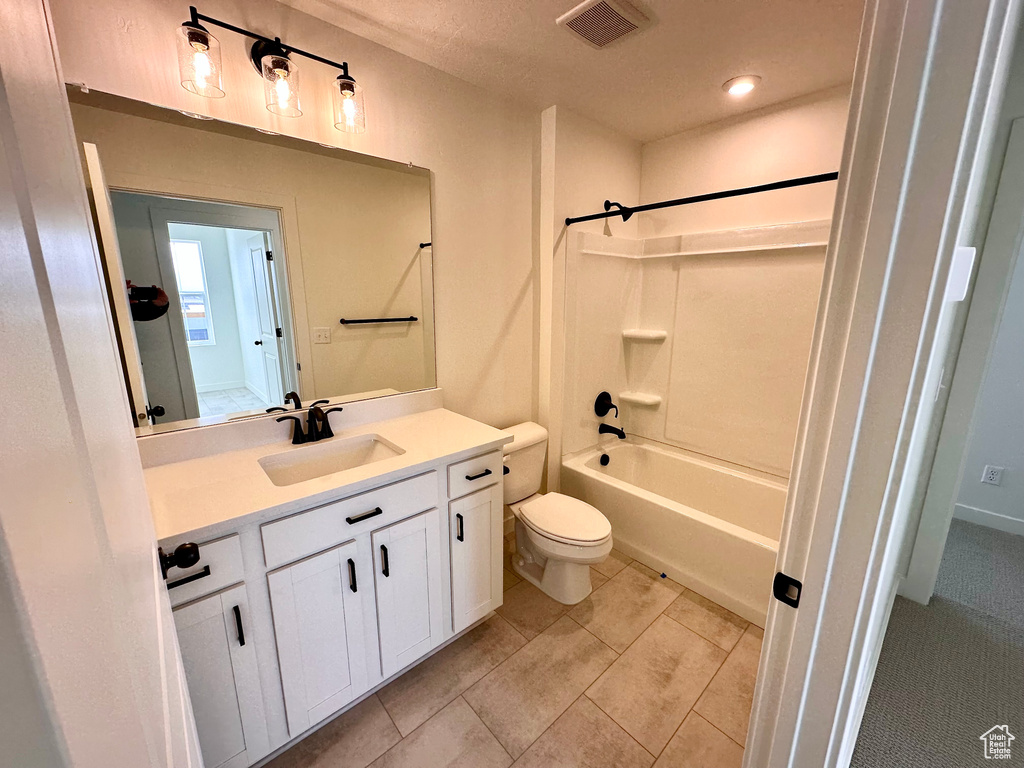 Full bathroom with toilet, bathing tub / shower combination, vanity, and tile flooring