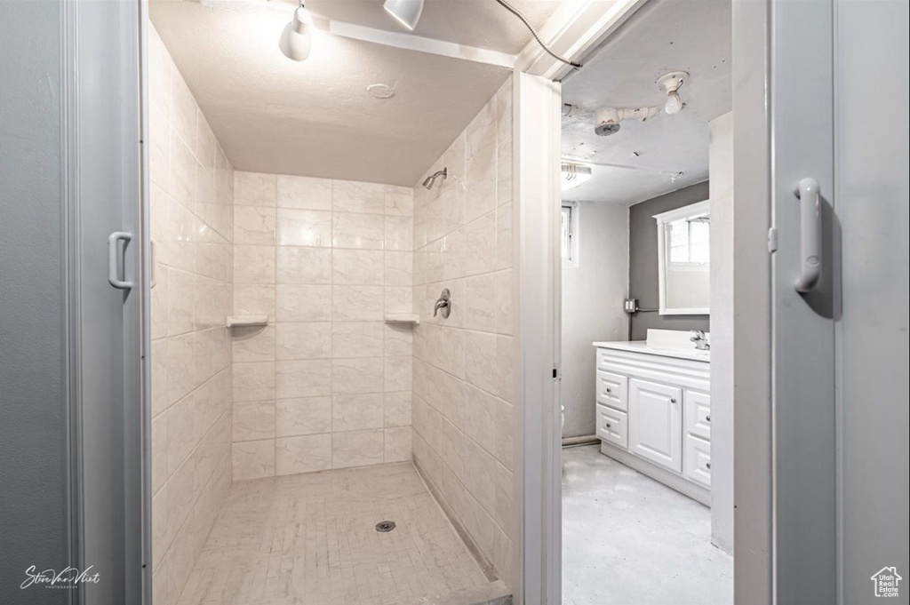 Bathroom featuring vanity and a shower with shower door