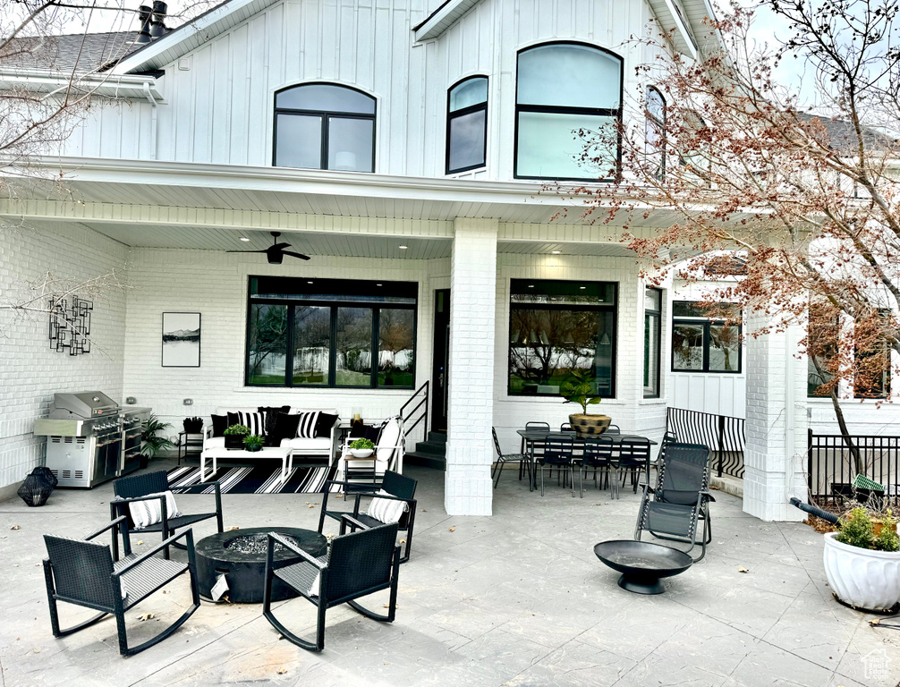 View of terrace featuring area for grilling, an outdoor living space with a fire pit, and ceiling fan