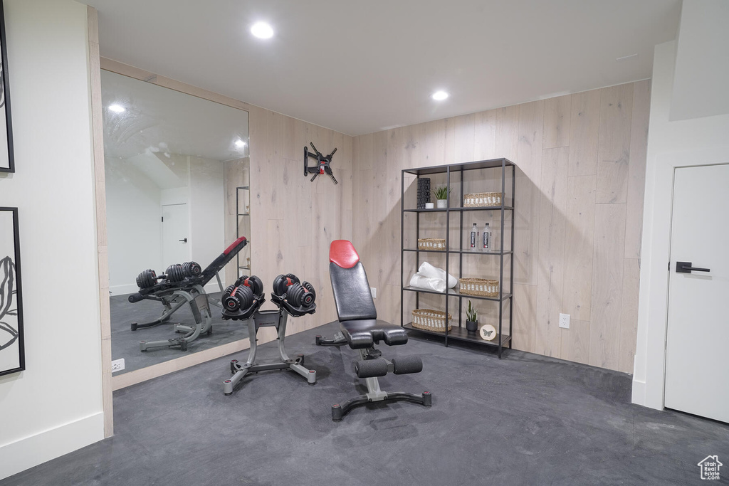Workout room featuring wood walls
