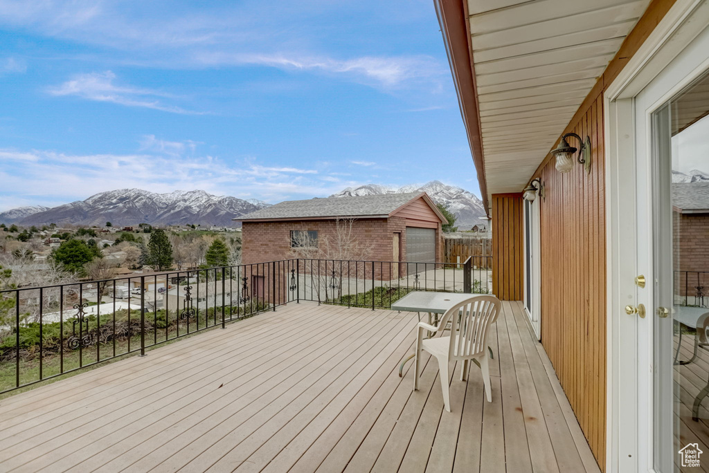 Wooden deck featuring a mountain view and a garage