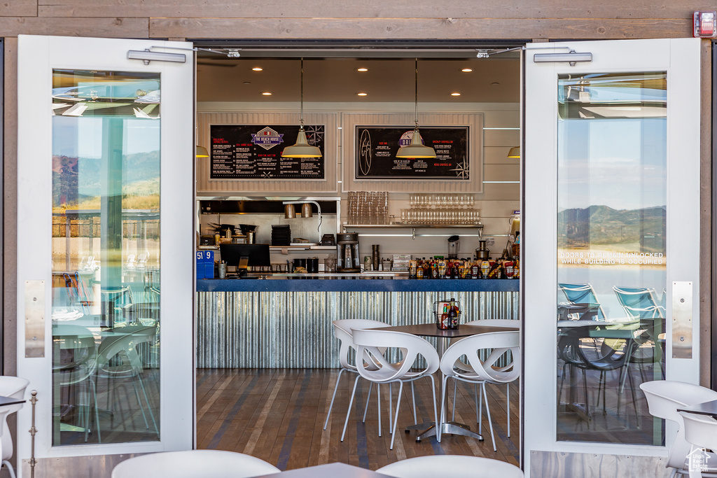 Bar featuring pendant lighting, hardwood / wood-style flooring, and a mountain view