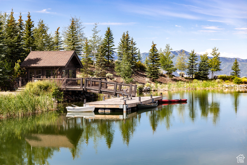 View of dock featuring a water and mountain view