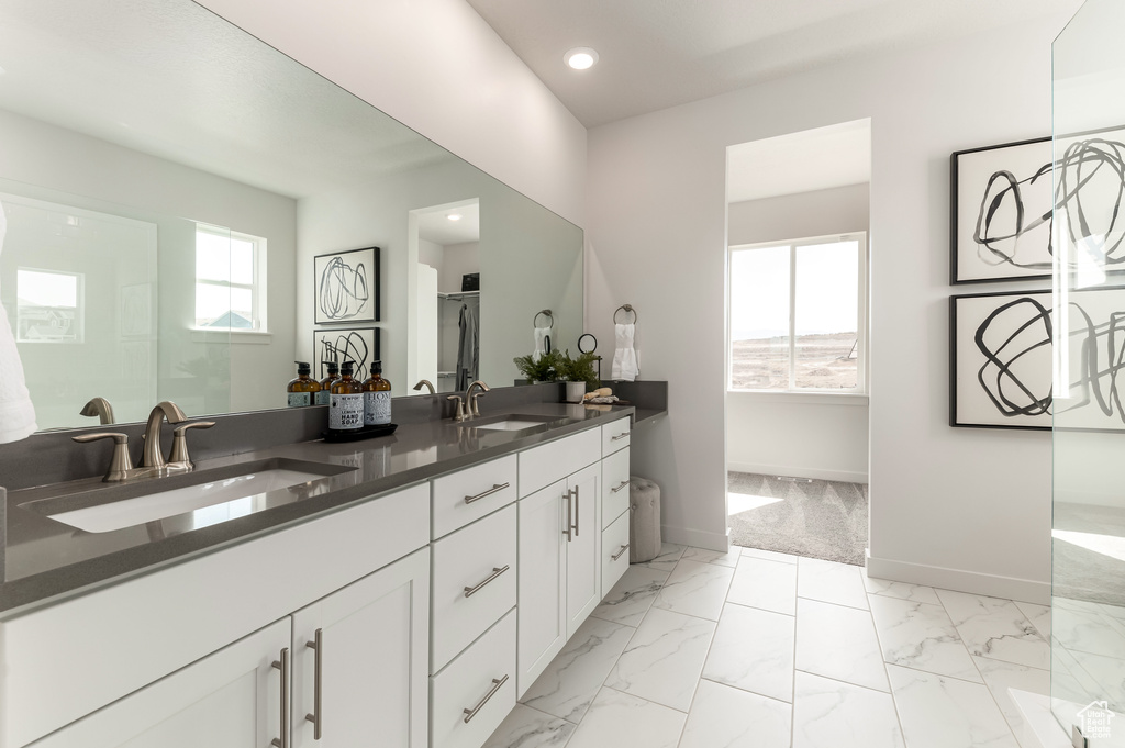 Bathroom featuring plus walk in shower, dual sinks, tile flooring, and large vanity