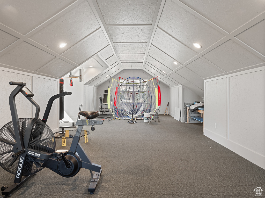 Exercise area featuring lofted ceiling, coffered ceiling, and carpet floors