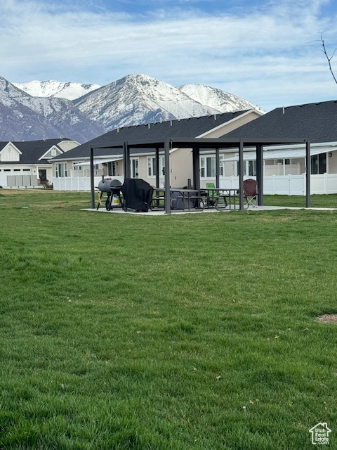 Back of property featuring a lawn and a mountain view