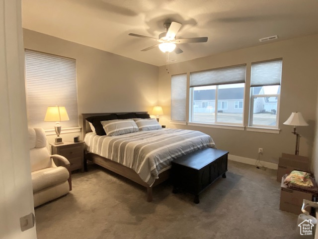 Bedroom featuring dark carpet and ceiling fan
