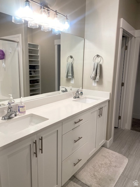 Bathroom with double sink vanity and hardwood / wood-style floors