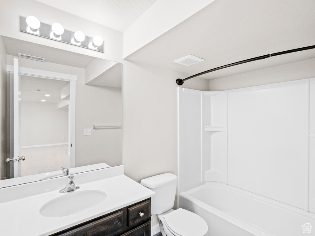 Full bathroom featuring toilet, shower / bathtub combination, and vanity