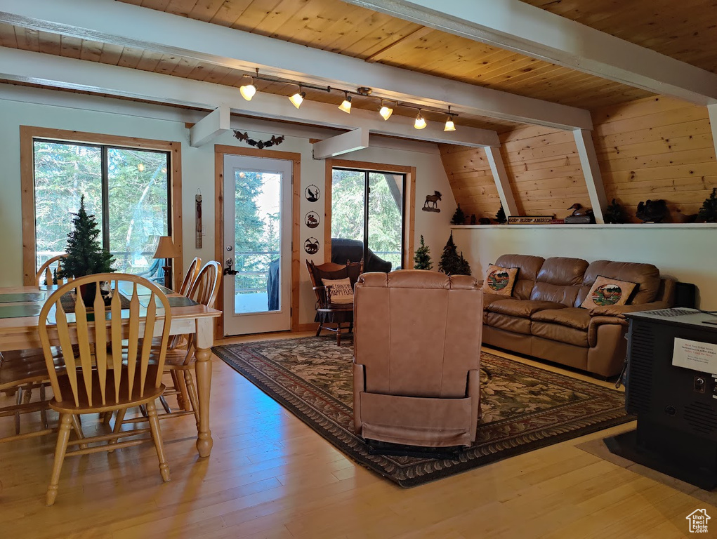 Living room featuring wooden ceiling, hardwood / wood-style floors, vaulted ceiling with beams, and rail lighting