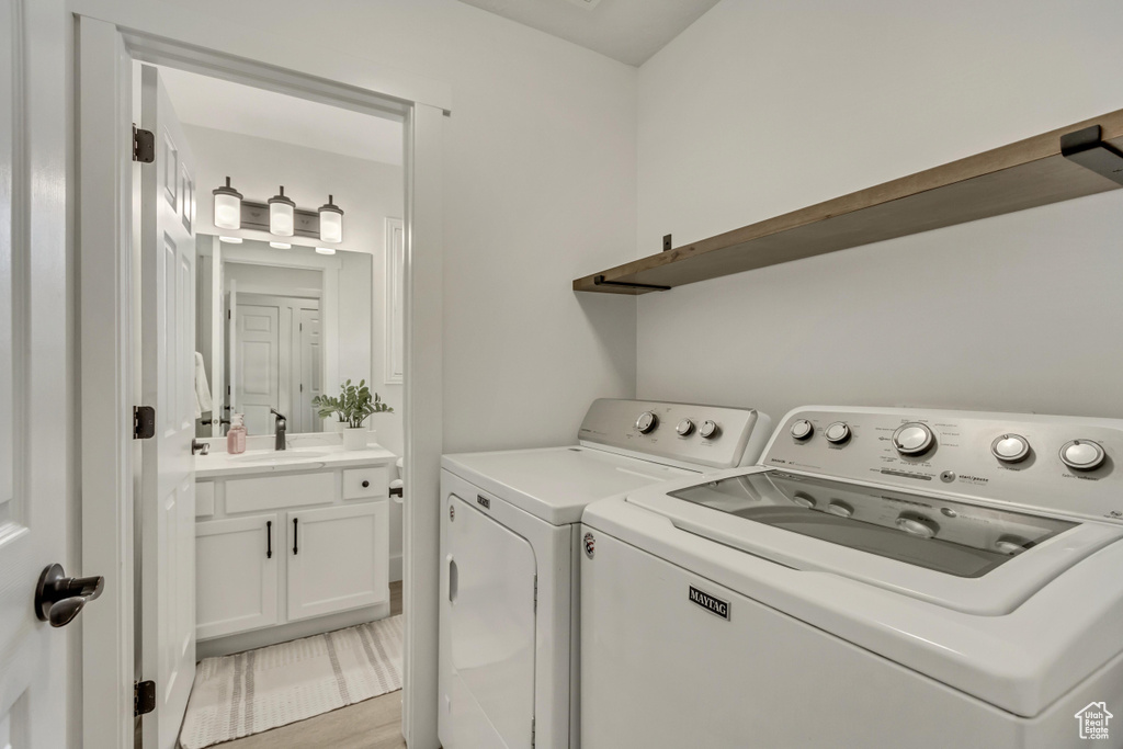 Washroom with sink and independent washer and dryer