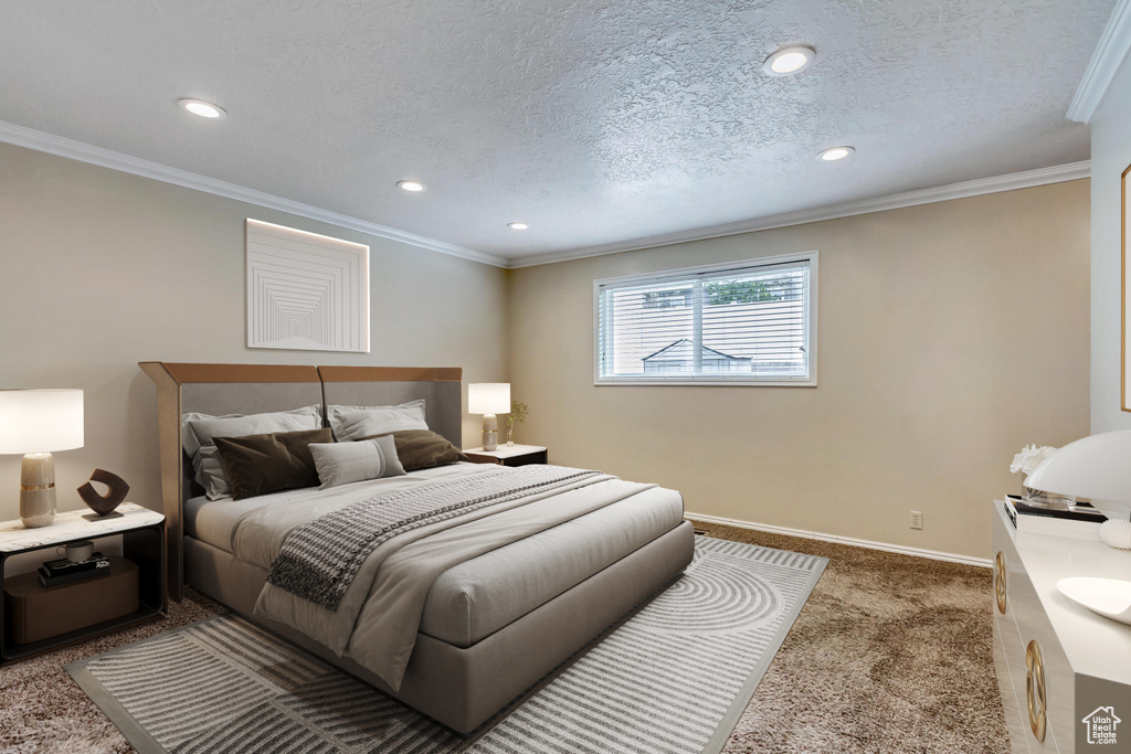 Carpeted bedroom with crown molding and a textured ceiling