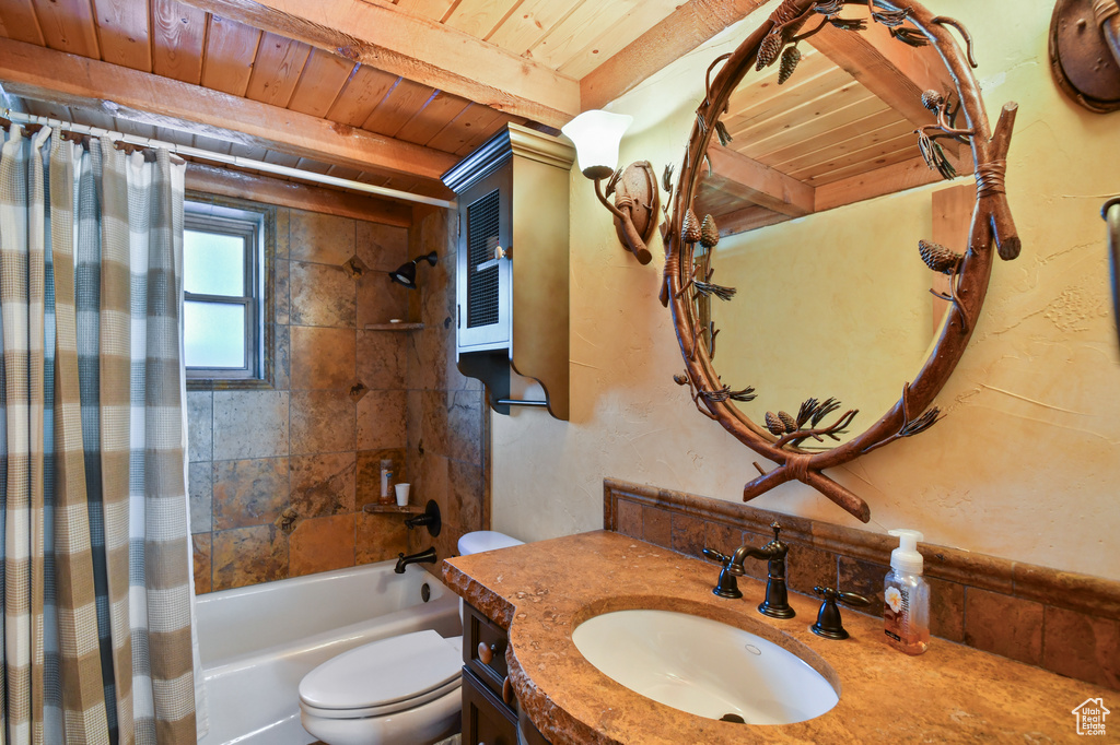 Full bathroom featuring toilet, shower / tub combo with curtain, wooden ceiling, and vanity