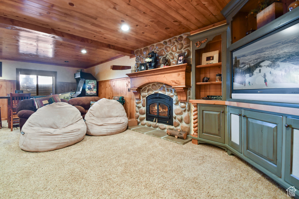 Living room with carpet, wood ceiling, and a fireplace