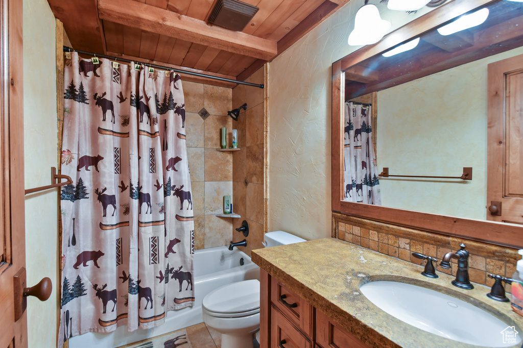 Full bathroom with toilet, vanity, wood ceiling, tile floors, and shower / tub combo