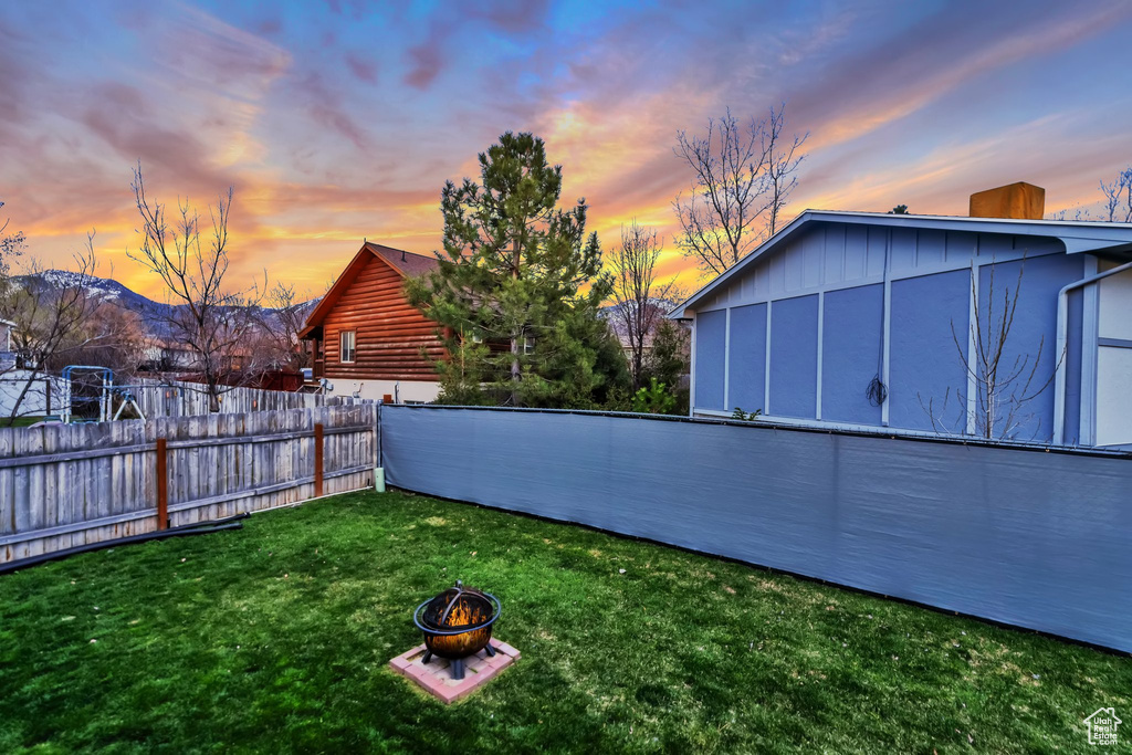 Yard at dusk with a fire pit