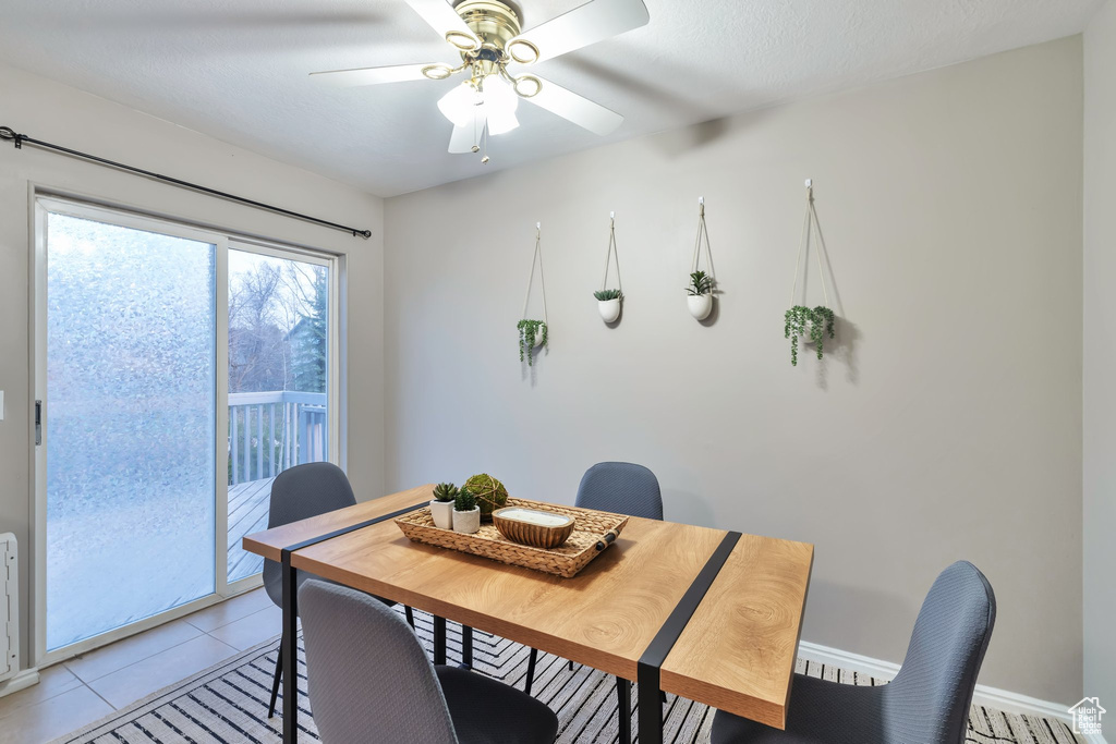 Tiled dining room with ceiling fan