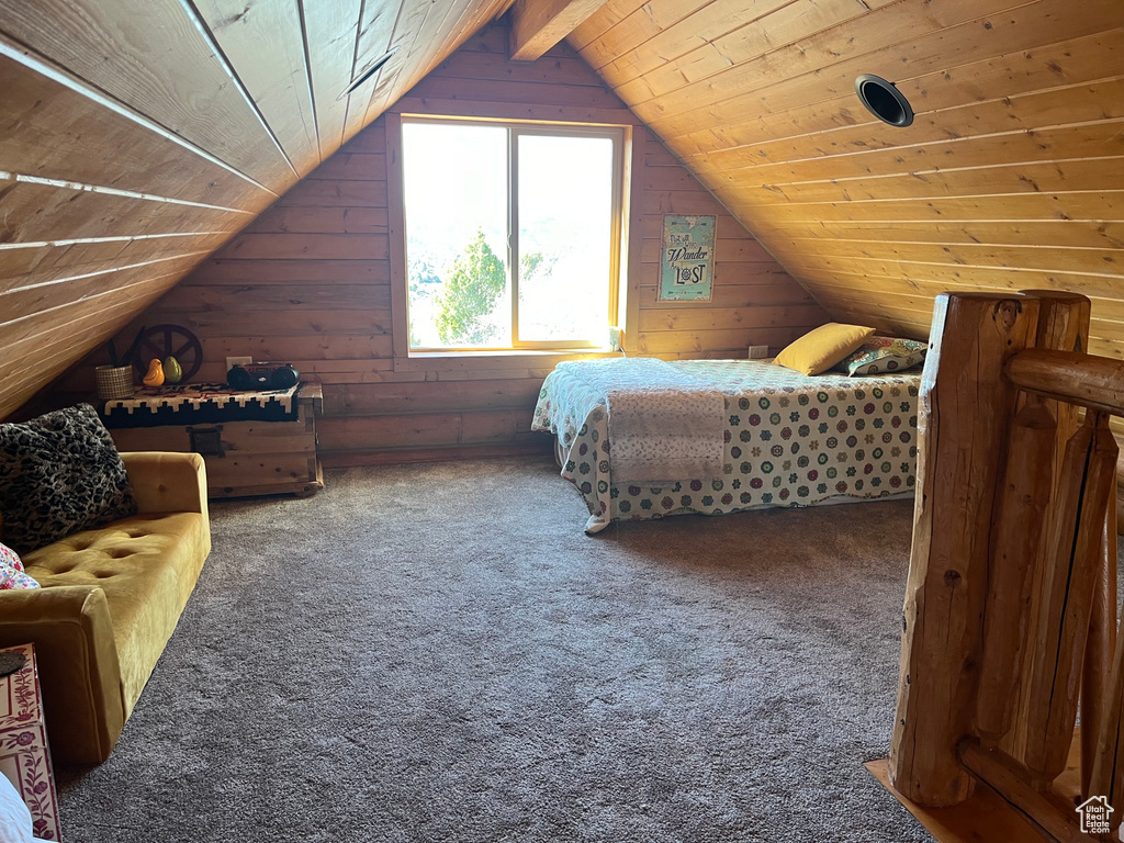 Bedroom featuring wood ceiling, lofted ceiling, wood walls, and carpet flooring